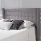 Tête de lit Kendrah capitonnée en tissu avec ailes, cloutée, réglable, format grand lit/très grand lit, par